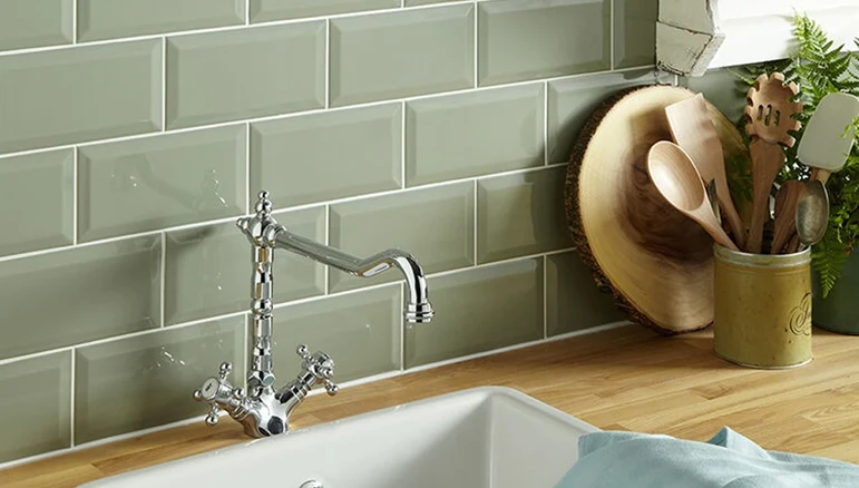 green kitchen tiles on a splashback in brick style.