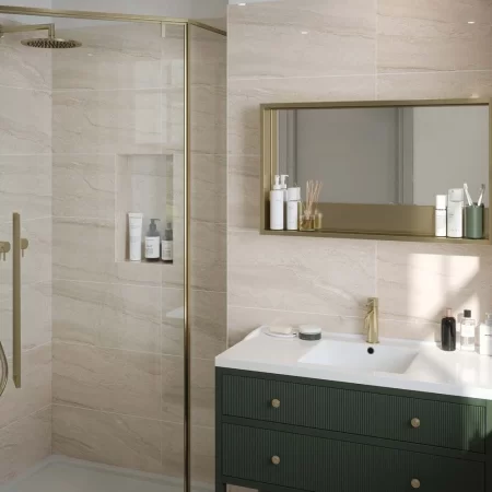 laurent beige 300x600mm ceramic wall tile in a bathroom with gold fixtures.