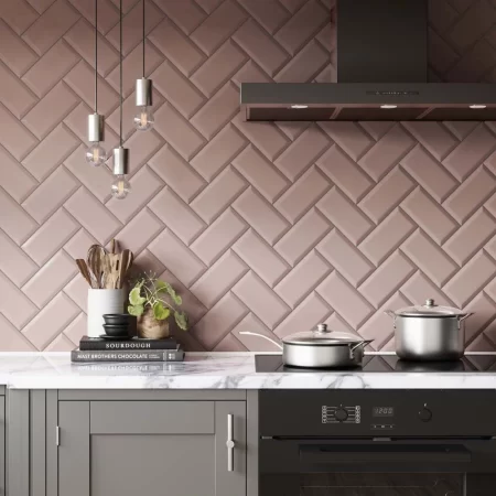 bevelled metro pink gloss 100x200mm ceramic wall tile in herringbone pattern on a kitchen splash back