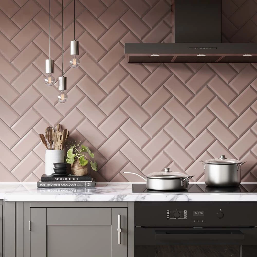 bevelled metro pink gloss 100x200mm ceramic wall tile in herringbone pattern on a kitchen splash back