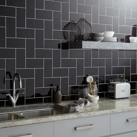 an image of flat metro black gloss ceramic wall tile in 100x200mm on a kitchen splash back in step ladder layout style