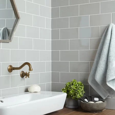 an image of flat metro light grey gloss 100x200mm ceramic wall tile on a kitchen splash back in brick style.