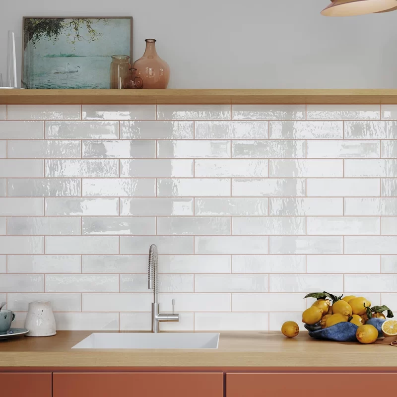 alcanar white wall tiles by mayolica, tiled on a splash back in a kitchen in brick bond style.